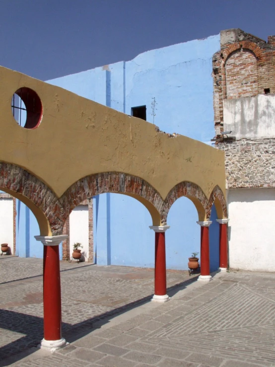 the arch - like columns of the old town have red painted pillars