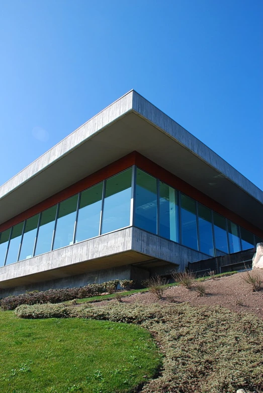 a very large, modern building on the side of a hill