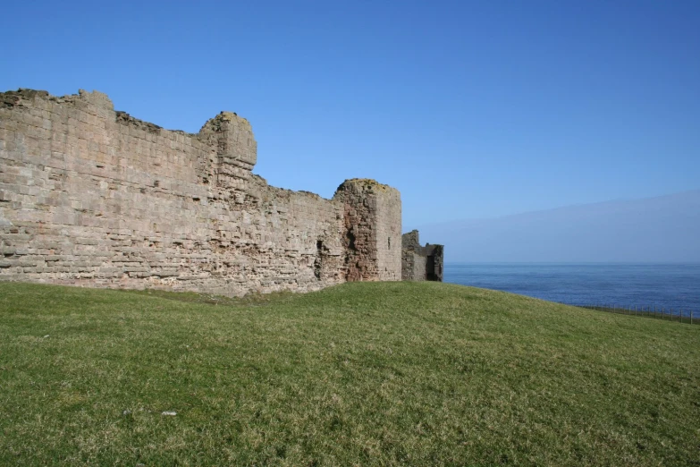 the grass is growing in front of this castle