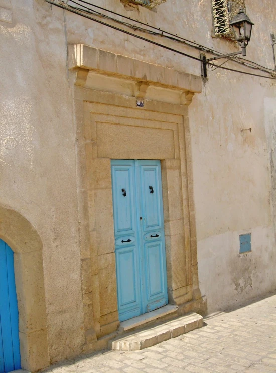 an outside view of some doors with one in the middle