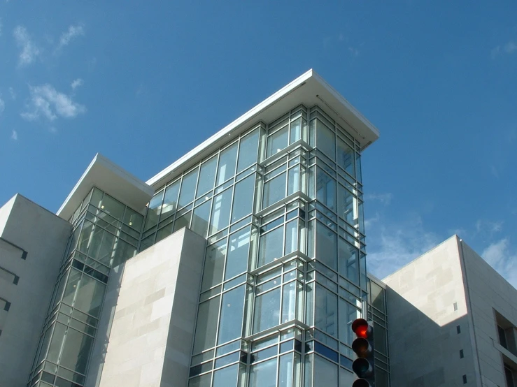 there are two street signs on a pole near the building