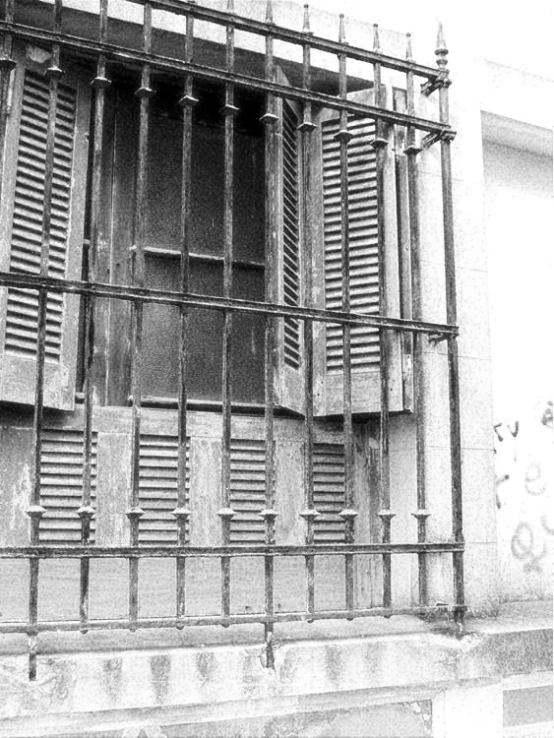 old  cell door with bars and shutters