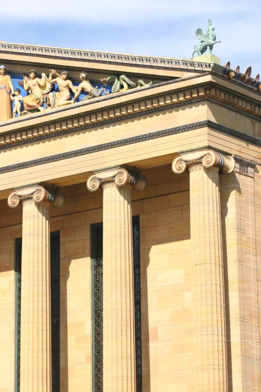 people sit on the top of statues at a building