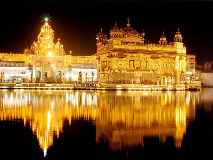 a very large and ornate building next to a body of water