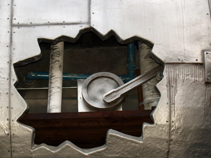 some metal tools are in a reflection on a wall