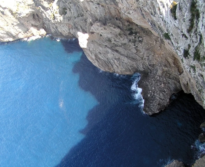 a view from the top of a cliff with water next to it