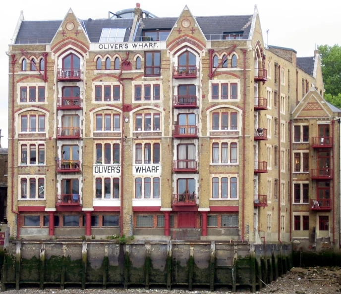 a tan brick building with several windows on the front