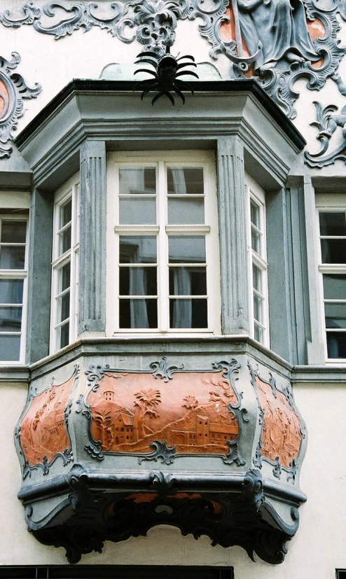 the top window of a building with decorative designs