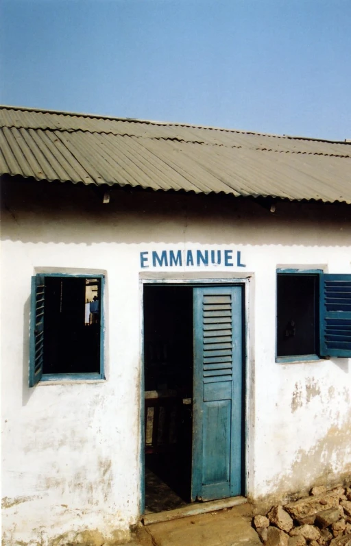 an image of a small building with blue shutters