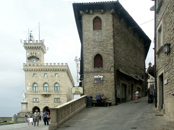 the building is built into the wall with three floors and a tower on top