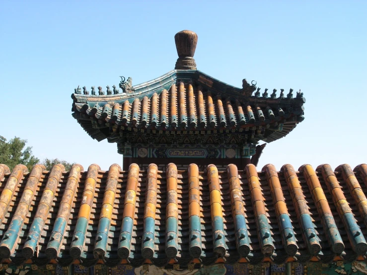 an ornate chinese temple features orange blue and gold tiles