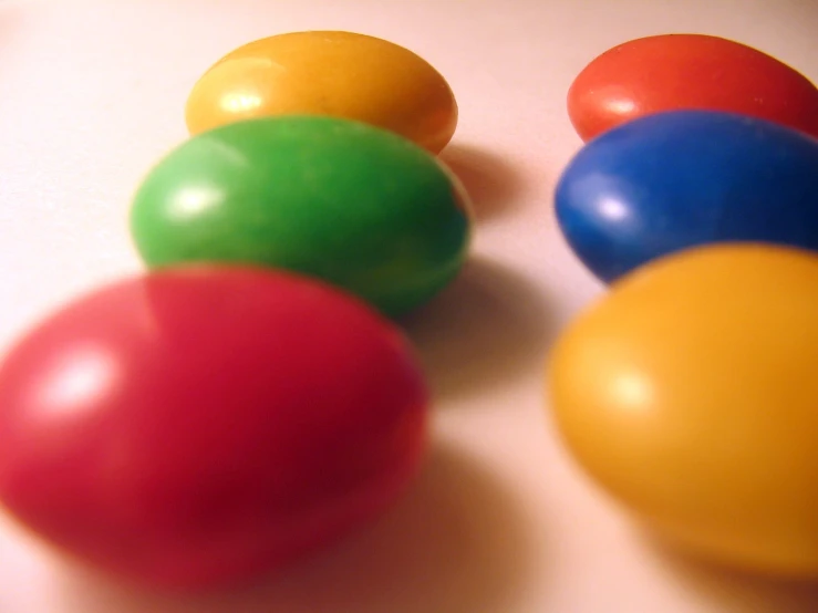 four colorful balls placed side by side in an arrangement