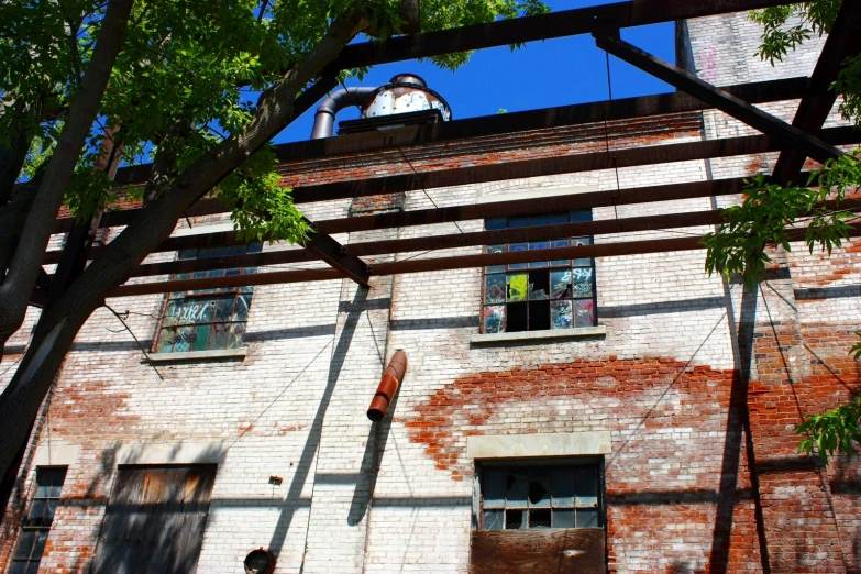 brick building with large windows and a clock tower above it