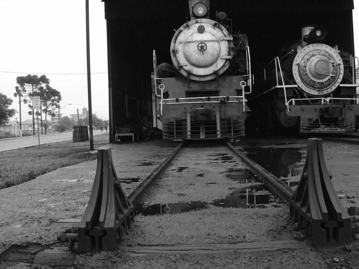two train engines side by side on the tracks