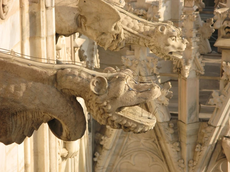 a close - up of two gargoyles on the outside of a building