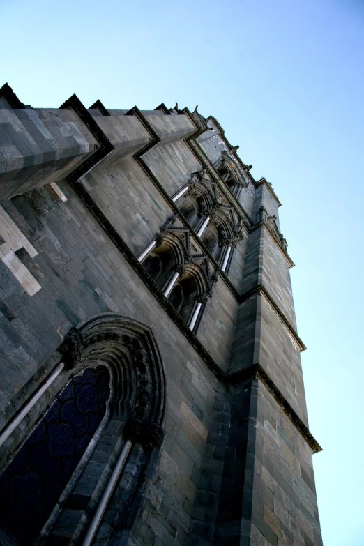 a large brick tower with windows and a clock on the top