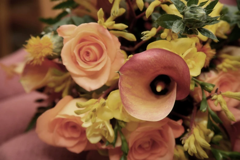 there is a large bouquet with yellow and pink flowers