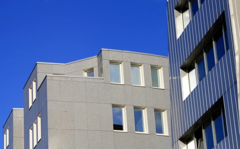 buildings are side by side in front of blue skies