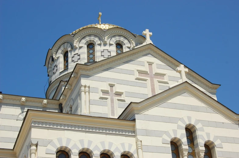 a church with a clock tower and decorative crosses