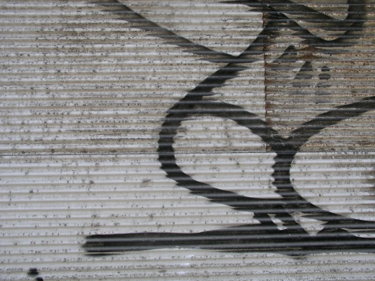a close up of the side of a building with a stenciled design