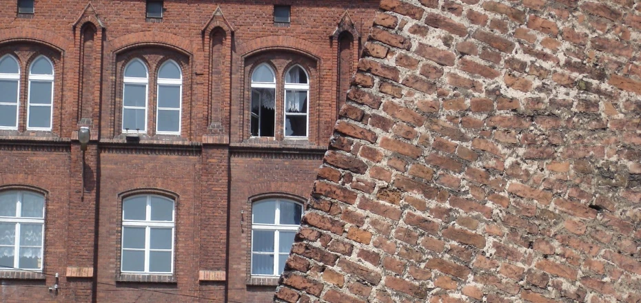 a very tall brick building with arched windows