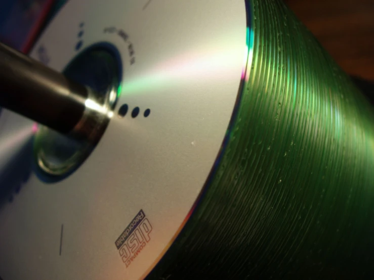 a dvd with a pen inside a green reel