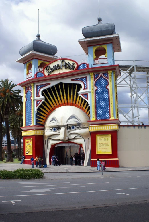 an entrance to a carnival center with big clowns