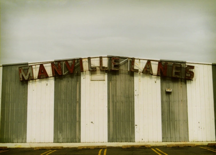 large white building with an advertit on it