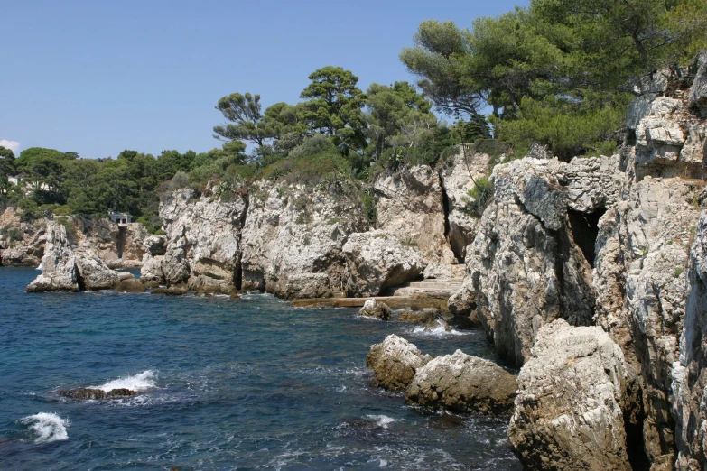 a view of the beach looking down on some rocks