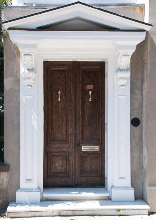 the door and pillars on the front of an apartment building