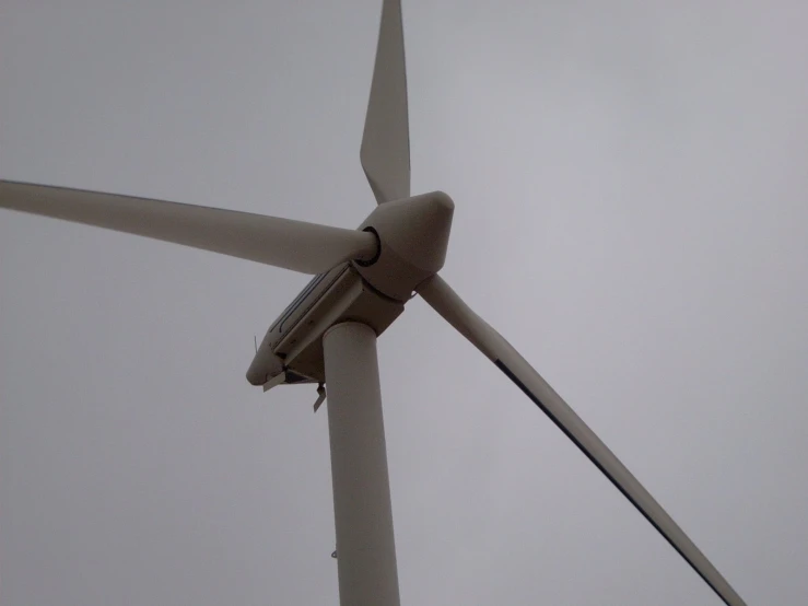 a large wind turbine is shown on a cloudy day
