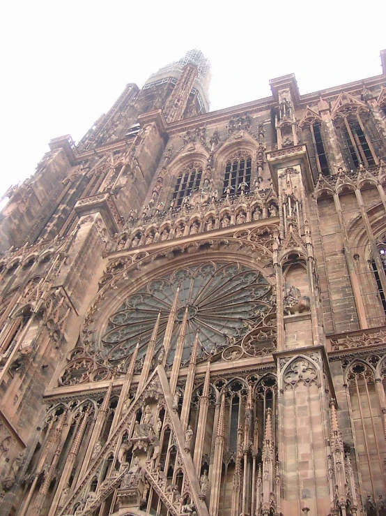 a church is pictured looking up at the steeples