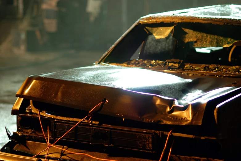 an old, burnt out car is on the street