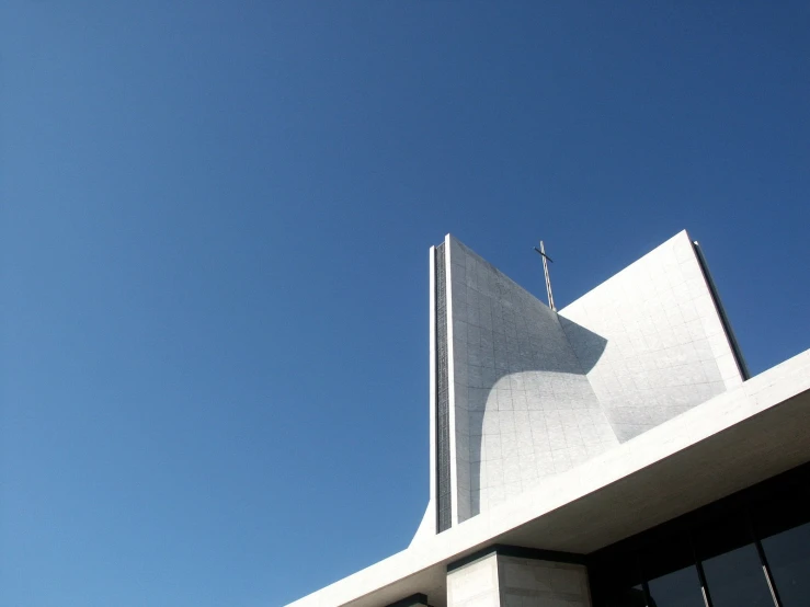 an image of a white building with a flag on top