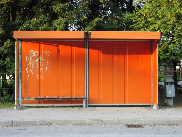 the orange box cars are lined up along the side of the street