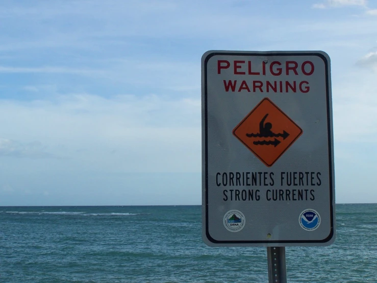 a sign warning people to beware of ordinent on the beach