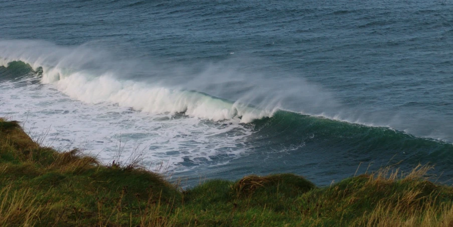 a large breaking wave in the middle of an ocean