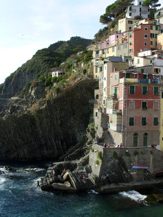 the water next to a large building by the ocean