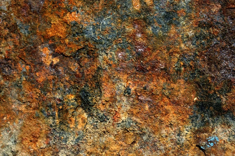 the color is orange, brown and black on this rock wall