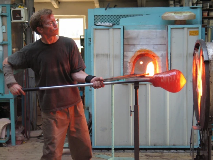 a man holding a stick in his right hand as he works on soing