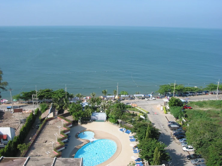 an aerial view of a pool with water and a beach