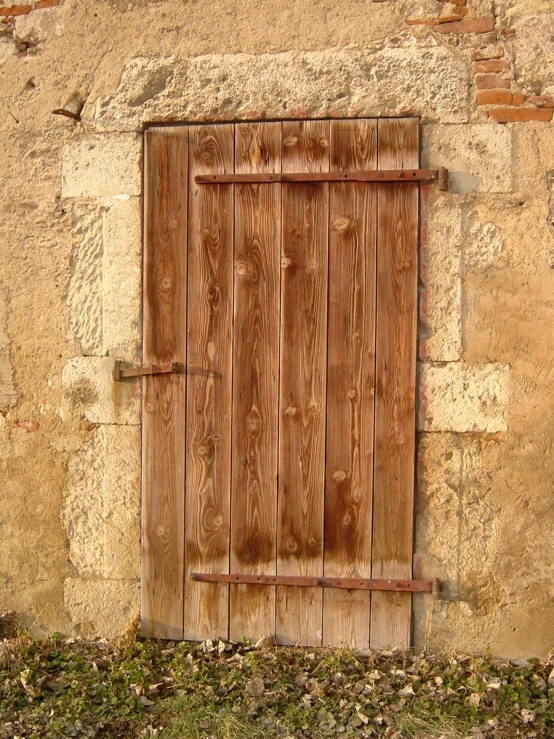 an open wooden door on an old stone building