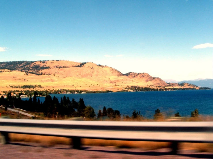 a view of mountains in the distance with a body of water near by