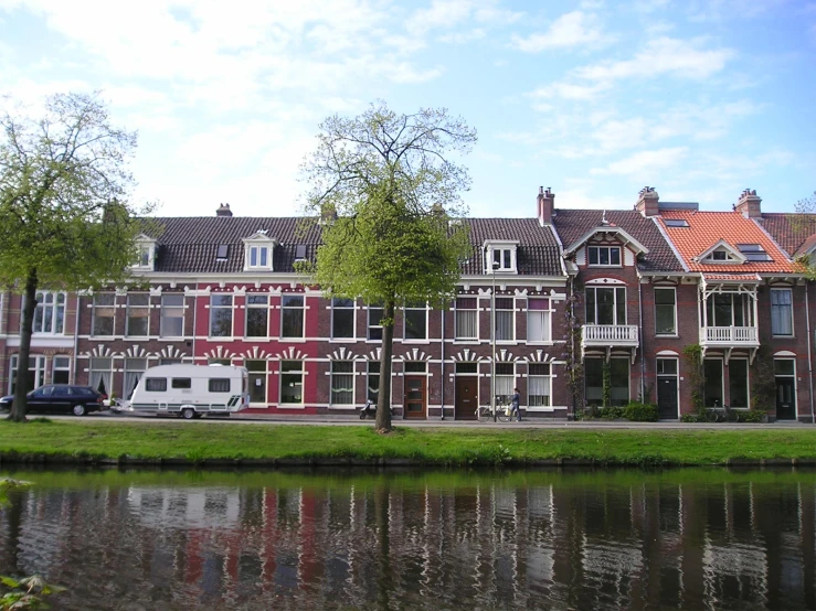 a building and car on the street by a body of water