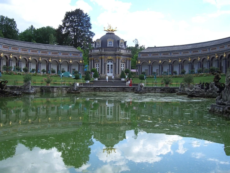 pond and patio near building, with fountain in foreground