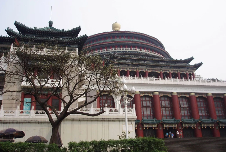 an asian building with a tree in front