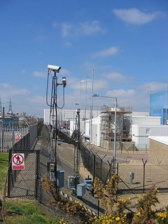 the view from an industrial street looking at power lines