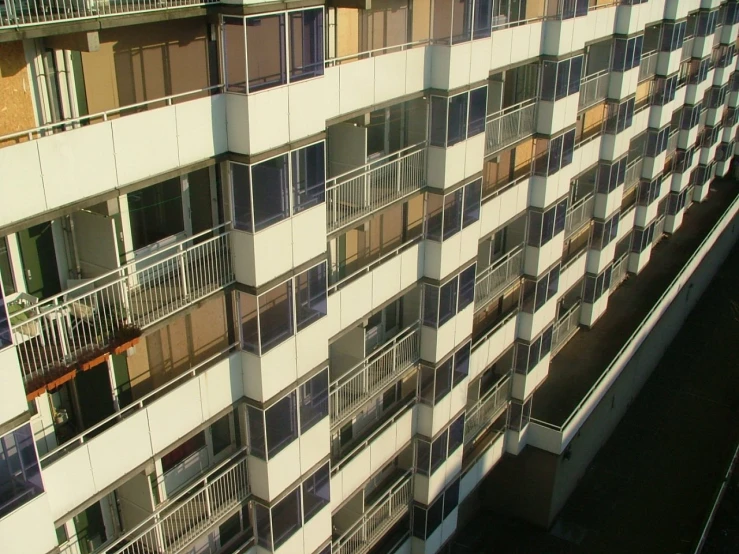 the building is big and has balconies in different windows