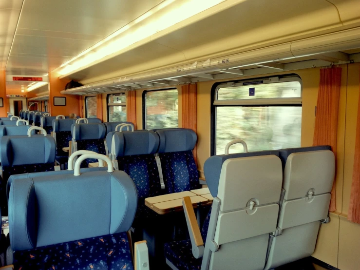 empty seats sit in the middle of a train