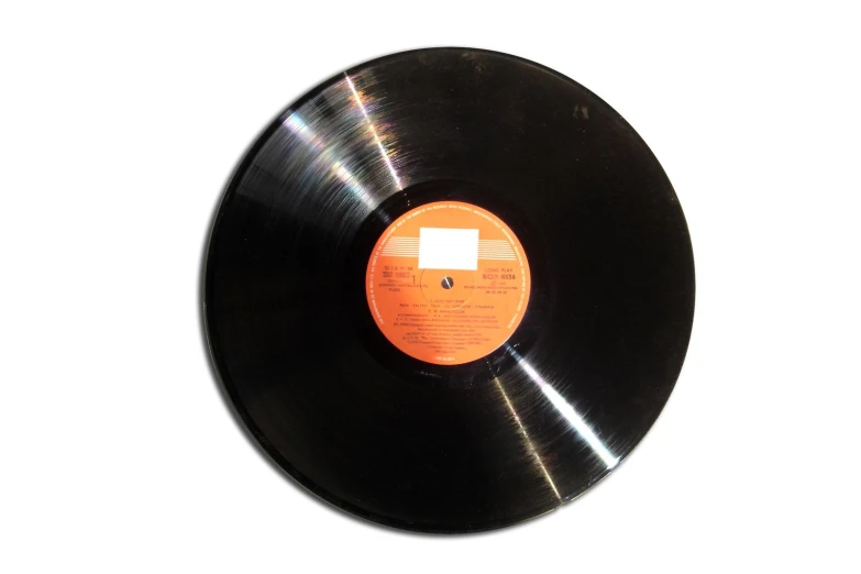 an old black record on a white surface